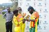 Jamaican Reggae star Riley (R) admires trophies presented to her by the Lady Cricket Cranes skipper Kevin Awino (L) and Janet Mbabazi (C) 